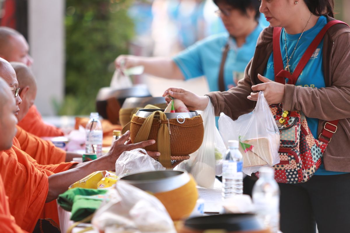 At an alms round, offerings go straight into the bowl rather than into the monk's hands